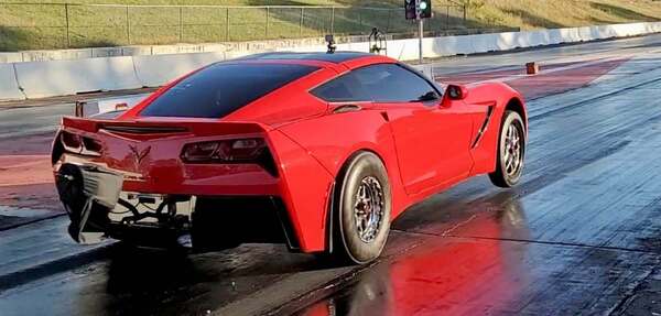 Red C7 Corvette launching at the track
